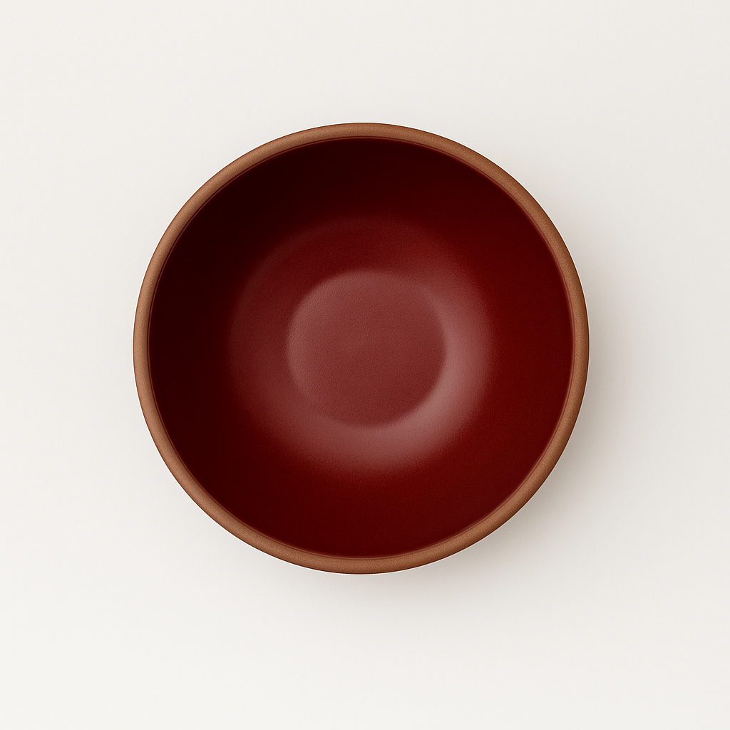 Cranberry red ceramic bowl on a white background