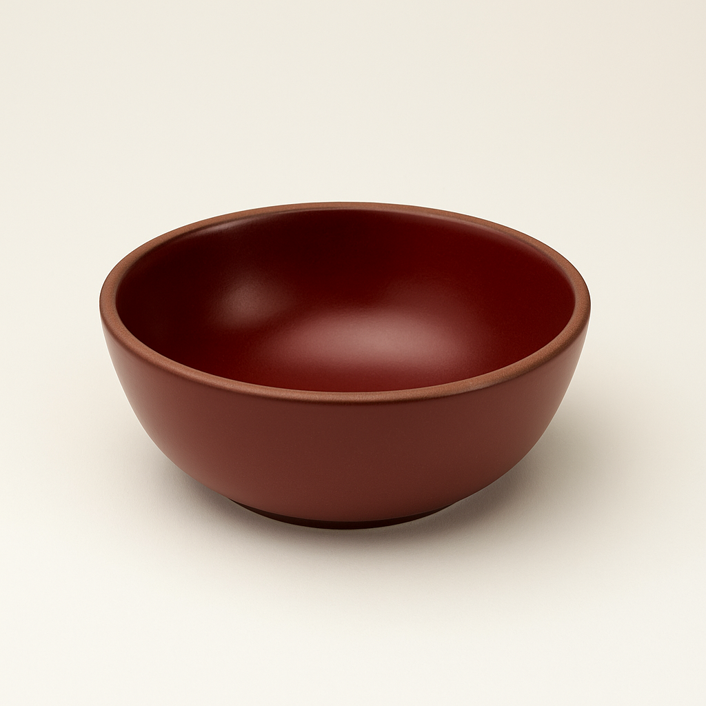 Cranberry red ceramic bowl on a beige background