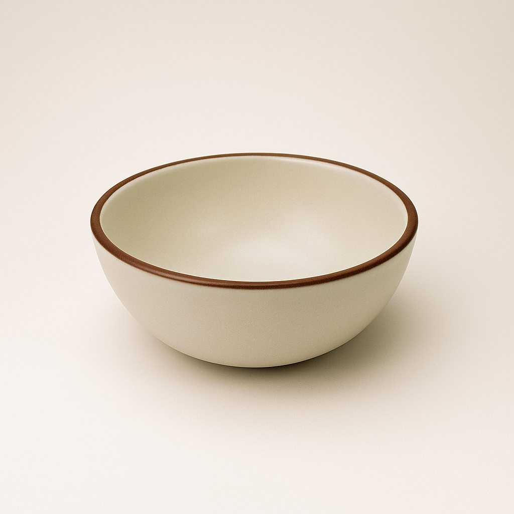 White ceramic bowl with brown rim on a beige background